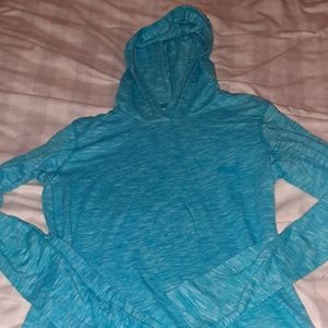 Long-sleeved Puma shirt athletic with hood and thumb holes on sleeve. Aqua blue.
